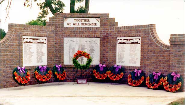 red brick monument with memorial plaques